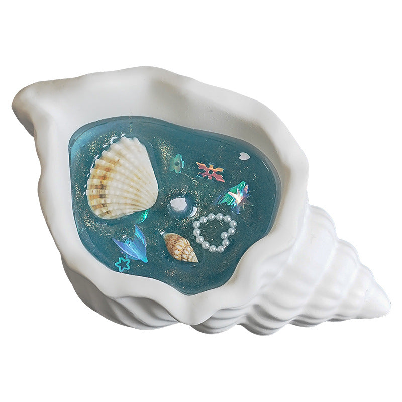 Ocean conch shell jelly wax candle with real seashells, close-up
