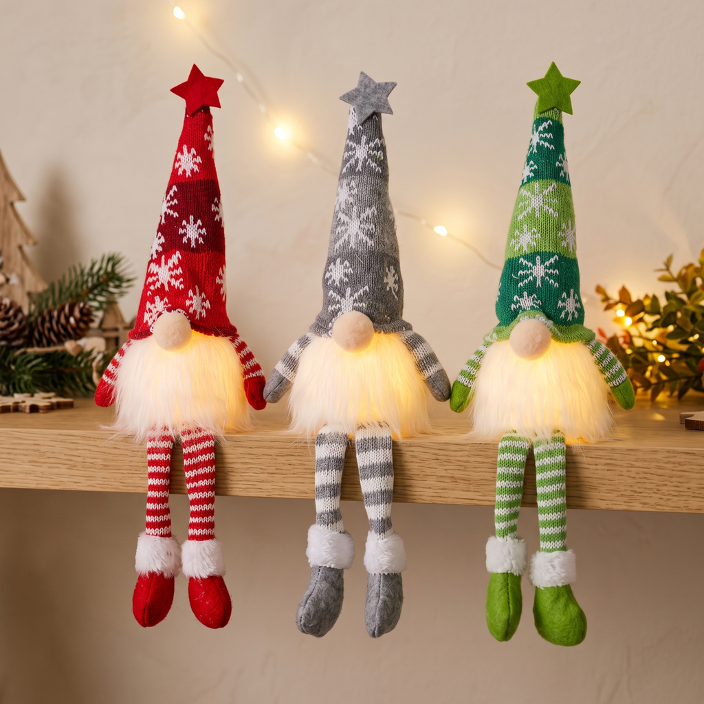 Three knitted light-up Christmas gnome dolls sitting on an oak shelf