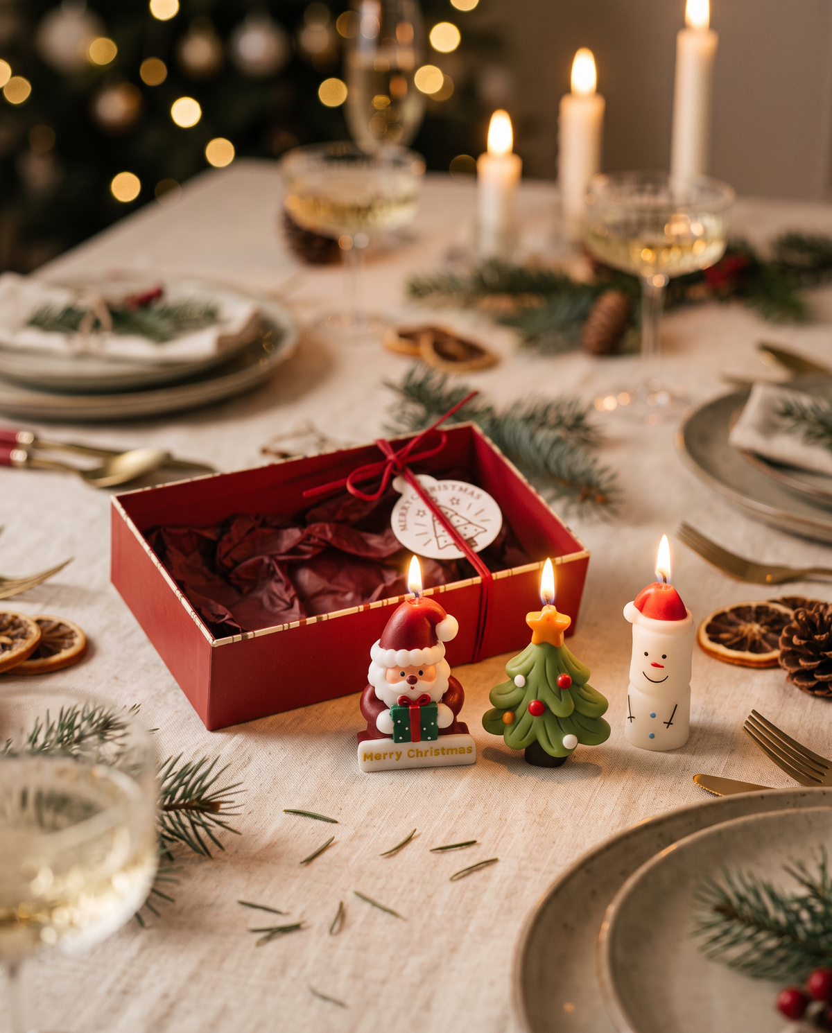 Christmas candle gift set in a red box on a styled holiday dinner table
